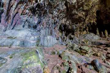 Nimara cave near Marmaris, Turkey inside. Stalactites stalagmites and streak formations in cave of Nimara Magarasi, Turkey. Stone walls and rocks in natural cave. stones covered with moss