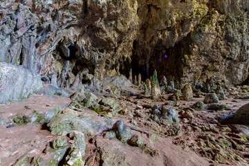 Nimara cave near Marmaris, Turkey inside. Stalactites stalagmites and streak formations in cave of Nimara Magarasi, Turkey. Stone walls and rocks in natural cave. stones covered with moss