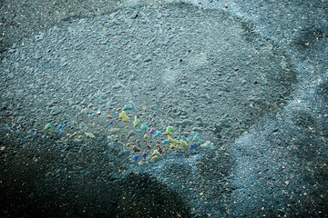 Oil spill on asphalt path showing pollution concept.
