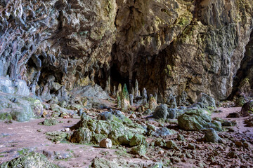 Nimara cave near Marmaris, Turkey inside. Stalactites stalagmites and streak formations in cave of Nimara Magarasi, Turkey. Stone walls and rocks in natural cave. stones covered with moss