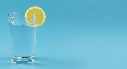 Clear glass of water with a lemon slice on a bright blue background