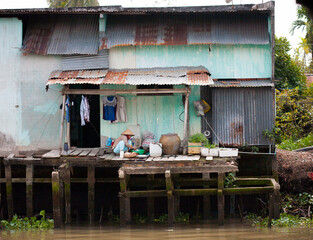 JAN 28 2014 - MY THO, VIETNAM - Houses by a river, on JAN  28, 2014, in  Mekong Delta, Vietnam