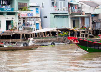 JAN 28 2014 - MY THO, VIETNAM - Houses by a river, on JAN  28, 2014, in  Mekong Delta, Vietnam