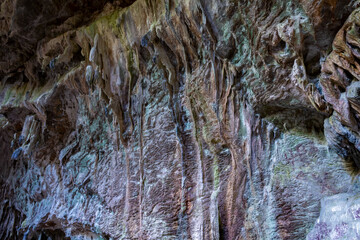 Nimara cave near Marmaris, Turkey inside. Stalactites stalagmites and streak formations in cave of Nimara Magarasi, Turkey. Stone walls and rocks in natural cave. stones covered with moss
