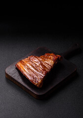 Grilled or barbecued pork or beef ribs with sauce. Cooked or smoked ribs