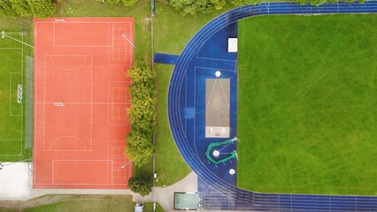 Aerial View of Sports Facility with Running Track and Multi-Sport Courts