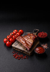 Grilled or barbecued pork or beef ribs with sauce. Cooked or smoked ribs