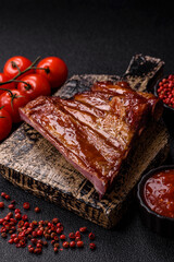 Grilled or barbecued pork or beef ribs with sauce. Cooked or smoked ribs
