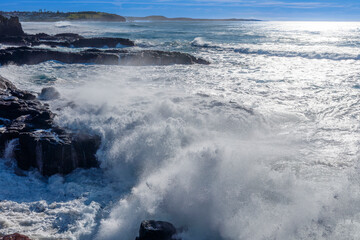 Photograph of waves crashing against a rocky coastline near the Illawarra town of Kiama Downs on the south coast of NSW, Australia.