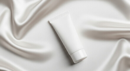 Monochromatic Beauty Concept Blank Cream Tube on Silky White Textured Background