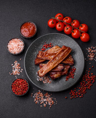 Grilled or barbecued pork or beef ribs with sauce. Cooked or smoked ribs