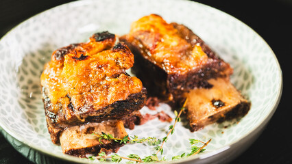 Tender, fall-off-the-bone braised beef short ribs, presented on a plate with fresh thyme. A rich, hearty, and deeply flavorful main course, perfect for comfort food imagery.