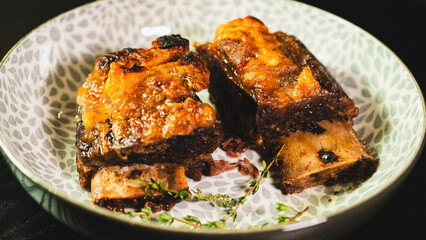 Tender, fall-off-the-bone braised beef short ribs, presented on a plate with fresh thyme. A rich, hearty, and deeply flavorful main course, perfect for comfort food imagery.