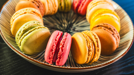 A beautiful assortment of vibrant and colorful French macarons, elegantly presented on a white plate. Perfect for dessert tables, pastry shop promotions, and food blog imagery.