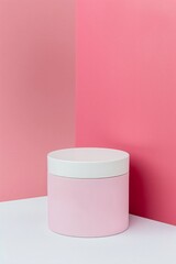 Minimalist Round Pink Box on White Table with Soft Pink Background in Creative Studio Setting