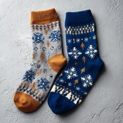 Pair of Christmas socks with patterns on blank surface