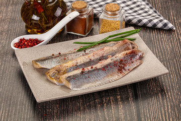 Salted marinated herring fillet with spices