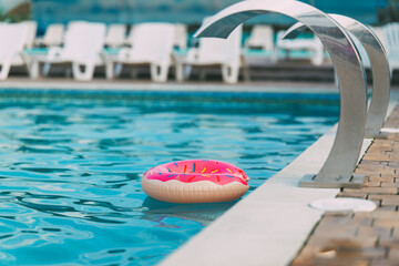 Donut float in a swimming pool on a sunny day