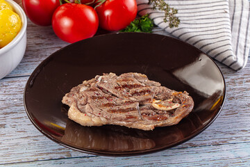 Grilled lamb steak with bone