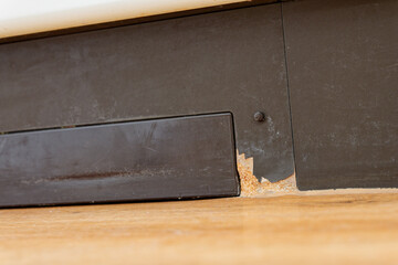 Water damage on kitchen baseboard and floor renovation, repair and home insurance concept