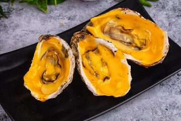 Baked oyster with cheddar cheese
