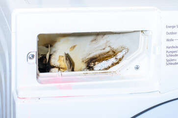 Close up of washing machine detergent compartment with mold