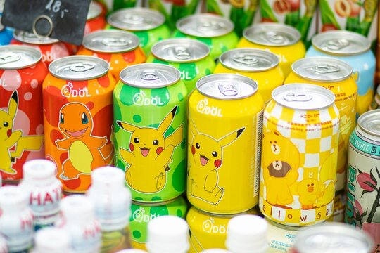 Colorful beverage cans QDOL featuring popular cartoon characters, including Pikachu and Charmander, arranged in a vibrant display at a local market
Warsaw, Poland - September 28, 2025