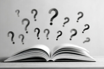 Open book with multiple question marks floating above symbolizing curiosity doubt and the quest for knowledge or answers in black and white style