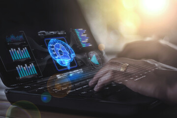 A network graph connected to a hologram of a brain, surrounded by glowing blue lines, floats on the screen of a computer that a businesswoman is using, powered by artificial intelligence technology.