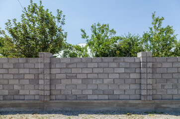 Grey cinder block fence wall