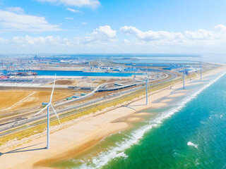 Wind turbine on the seashore. Renewable and natural energy sources. Green energy. Heavy industry. Drone view of wind generators. Waves and beach.