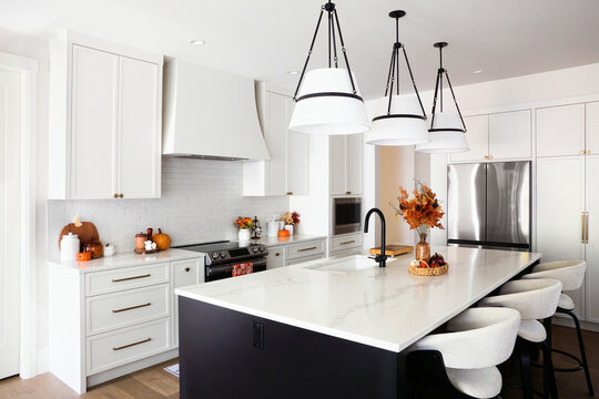 Beautiful modern kitchen with autumn cookware and decor display.