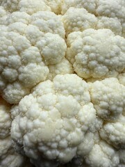 Close-up of fresh cauliflower. Texture of florets. Natural organic vegetables, healthy eating, vegetarianism, and the production of vegetables.