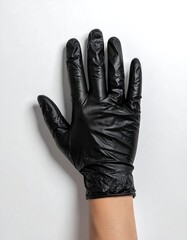 Black latex glove on hand against a white background