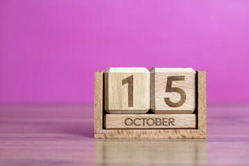 Wooden block calendar displaying october 15 date