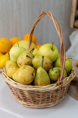 Fresh assortment of ripe pears in a woven basket, surrounded by vibrant oranges, showcasing natural colors and textures, perfect for healthy lifestyle concepts and culinary themes