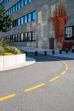 Modern business district with curved cycling path and autumn leaves, clarity and sustainable Scandinavian mobility background for editorial and branding use