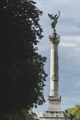 statue monument next to tree leaves