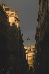old lantern hanging over street at dusk