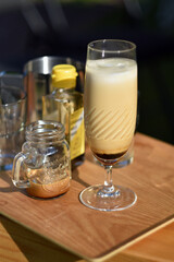Iced coffee latte served in elegant glass on wooden table