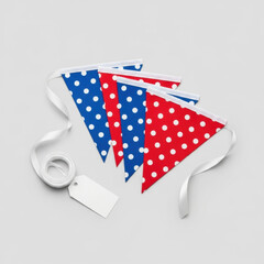 Three triangular red, blue polka dot bunting flags, white satin ribbon with decorative loop, gift tag, isolated on transparent, bright high-key studio lighting. Concept for premium product display