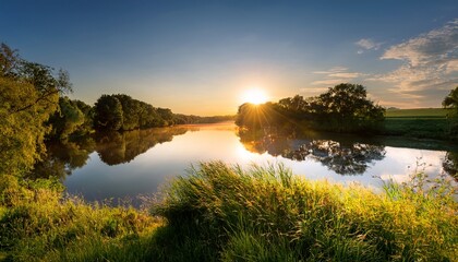 A Beautiful Evening Scene On The River With The Sun Reflecting Beautifully In The Water