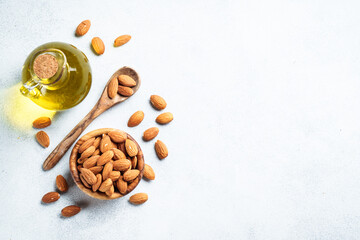 Almond nuts in wooden bowl at white background.