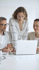 Obraz premium Business people team collaborating on a project, analyzing data on a laptop during a productive office meeting, fostering teamwork and strategic planning