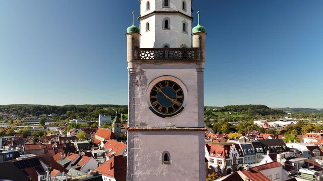 Close up drone shot of Blaserturm clock tower Ravensburg, revealing Marienplatz square from above Germany