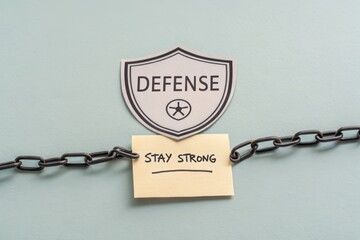 Defense shield symbol protecting a Stay Strong text message