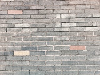 Closeup of a brick wall shows missing bricks and its texture