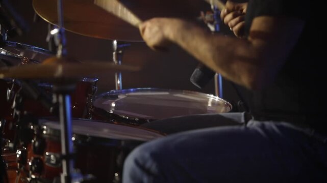 Montage of a musician intensely playing both a drum kit (cymbals) and bongo drums, highlighting dynamic percussion and rhythmic performance in a studio setting.
