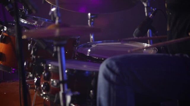 Montage of a musician intensely playing both a drum kit (cymbals) and bongo drums, highlighting dynamic percussion and rhythmic performance in a studio setting.