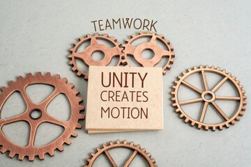Wooden sign with gears representing teamwork and unity